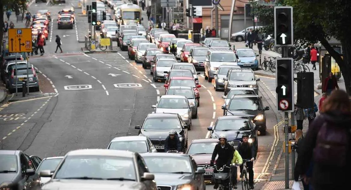 Busy town centre traffic with cyclists and pedestrians